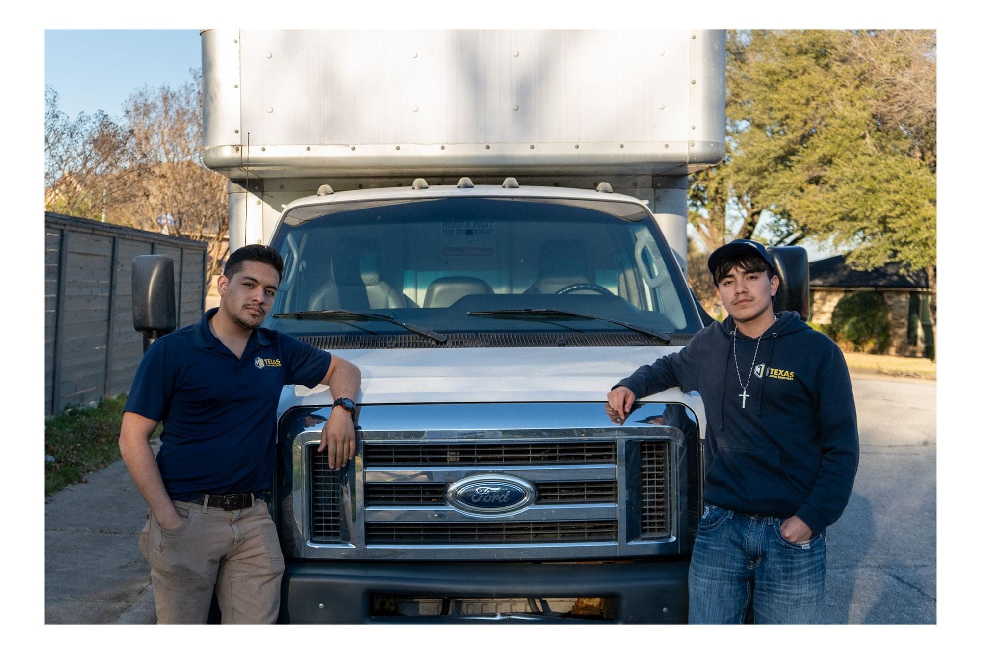 Erick (left) and Jo (right) standing in front of the Texas Junk Brothers truck in Dallas